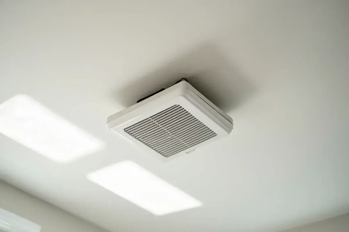New white ceiling supply register installed in a bedroom after a duct replacement